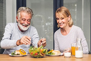 An older couple eating a healthy meal in their kitchen