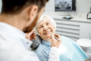 An older woman getting a dental checkup from her dentist