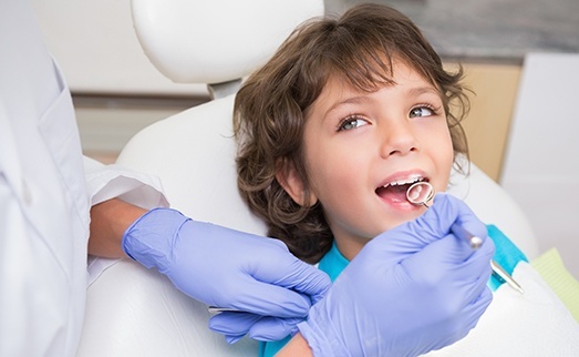 Child receiving dental treatment