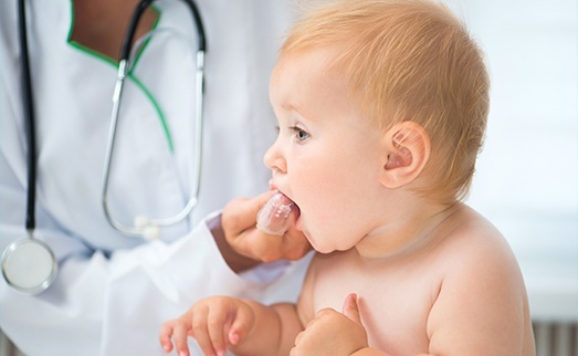 Baby receiving dental exam