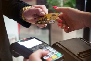 Man extending credit card for payment 