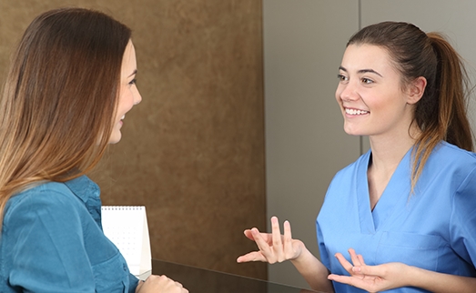 Dental patient checking in at reception desk