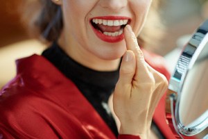 Woman pointing to her tooth