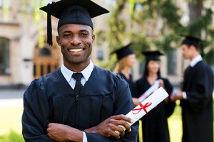 Many smiling at his graduation ceremony