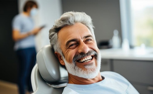 Happy older man in dental treatment chair