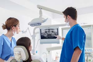 dentist showing a patient their X-rays