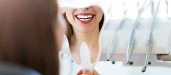 Closeup of smile in handheld mirror