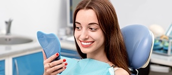 Woman looking at smile in the mirror