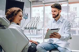 dentist showing a tablet to a patient