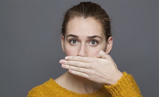 Woman covering her mouth