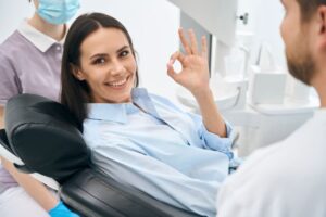 Happy dental patient making OK sign